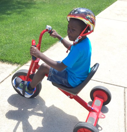 He told us that he'd never ridden a bike before, and we think this must be true, based on how difficult it was for him. This still-like-new tricycle that was Owen's was the perfect size for him, and the straps on the pedals were just what he needed to help him learn to pedal. He was beside himself with joy when we told him that this is now his trike. 